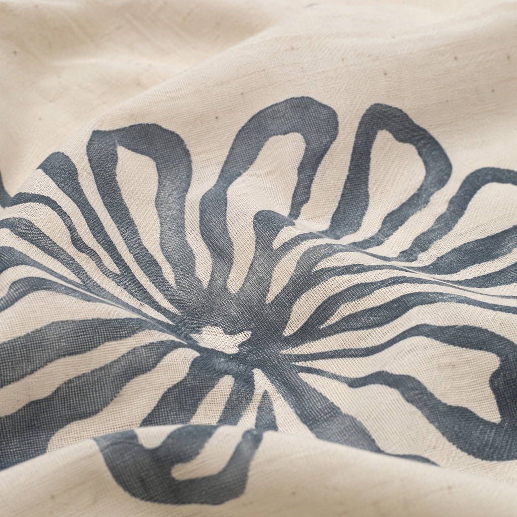 Textured fabric with a blue floral pattern on a beige background
